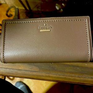 Kate Spade wallet brown in good used condition rip on one side of the id holder